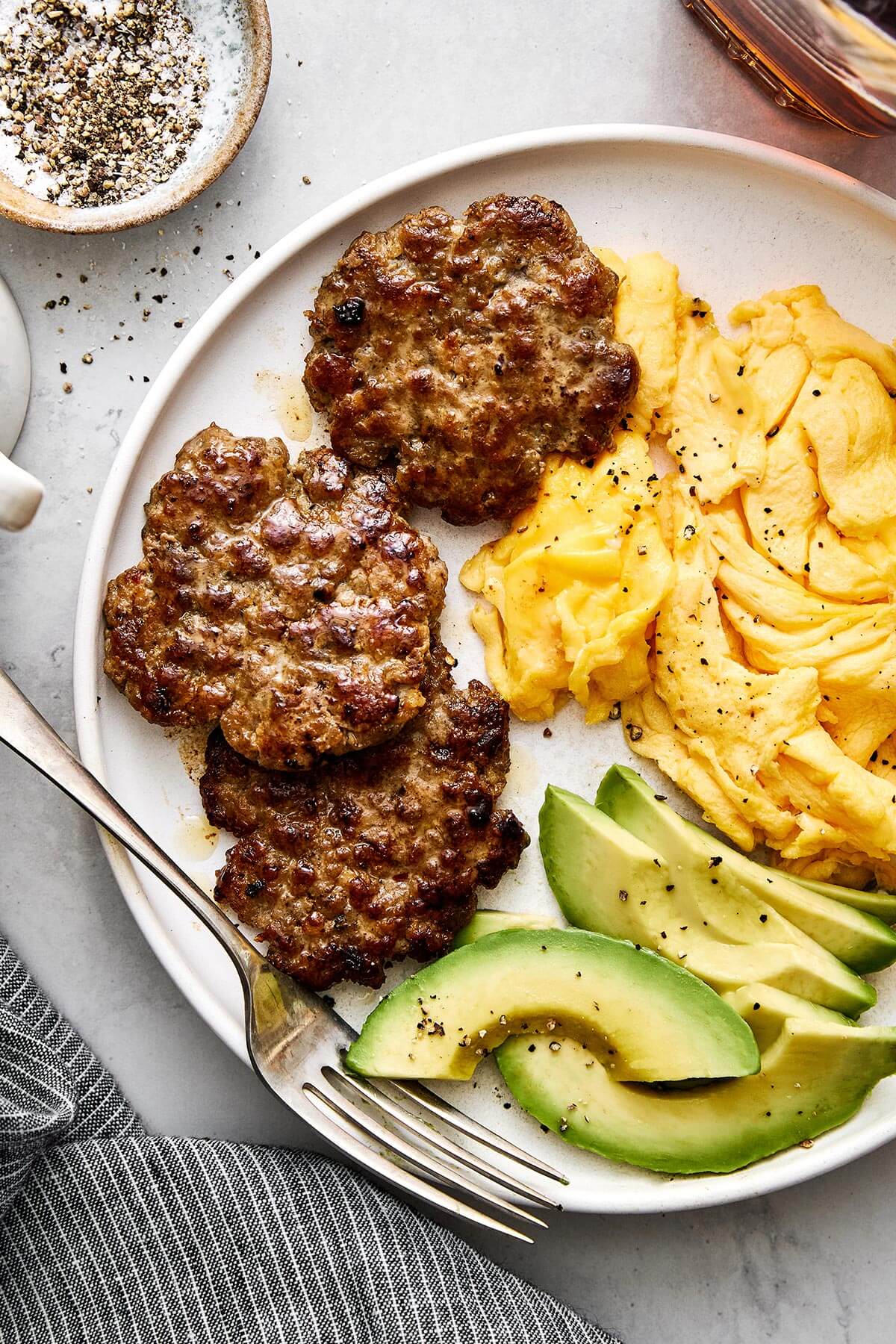 Breakfast plate of breakfast sausages and eggs.