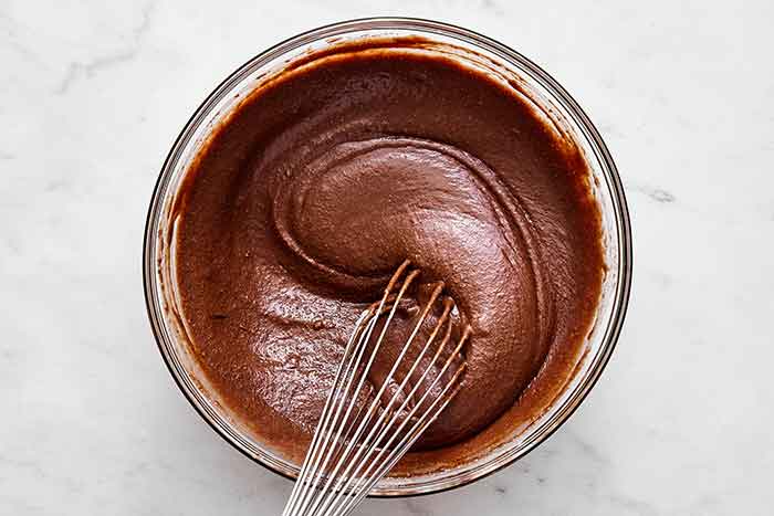 Making chocolate cake batter.