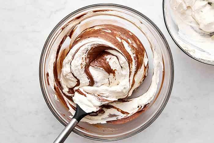 Folding cream into chocolate for mousse.
