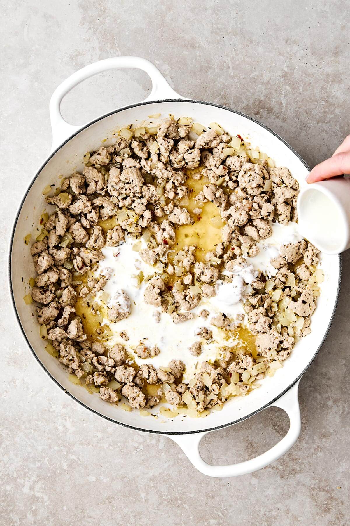 Making creamy pesto ground turkey skillet.