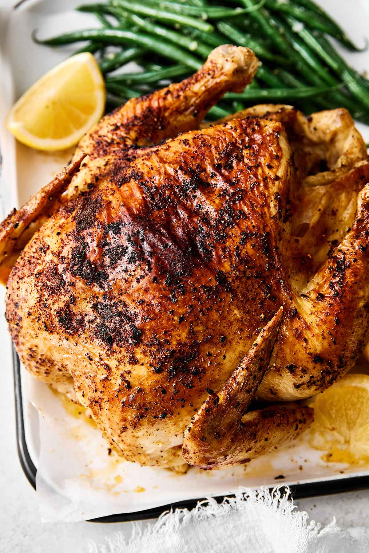 Air fryer whole chicken in a baking dish.