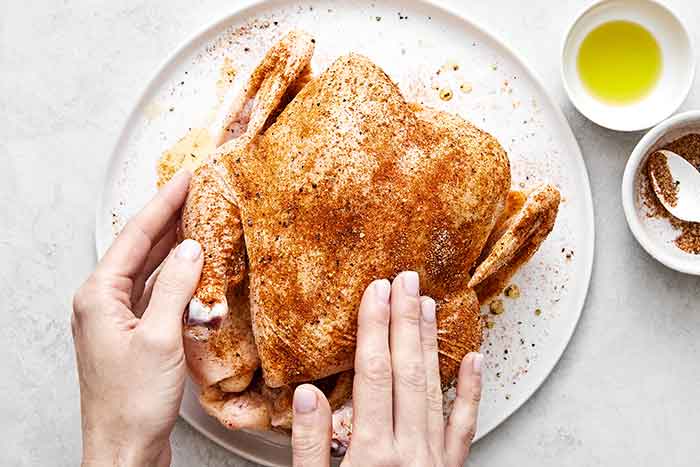 Coating chicken with seasoning.