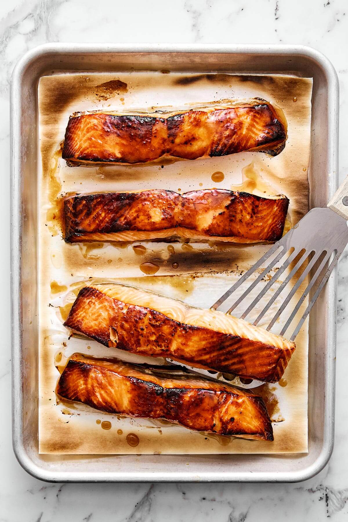 You'll crave this miso salmon time and again! It's incredibly simple, packed with umami flavor, and broiled to perfection in 7 minutes! Broiled miso salmon on a sheet pan.