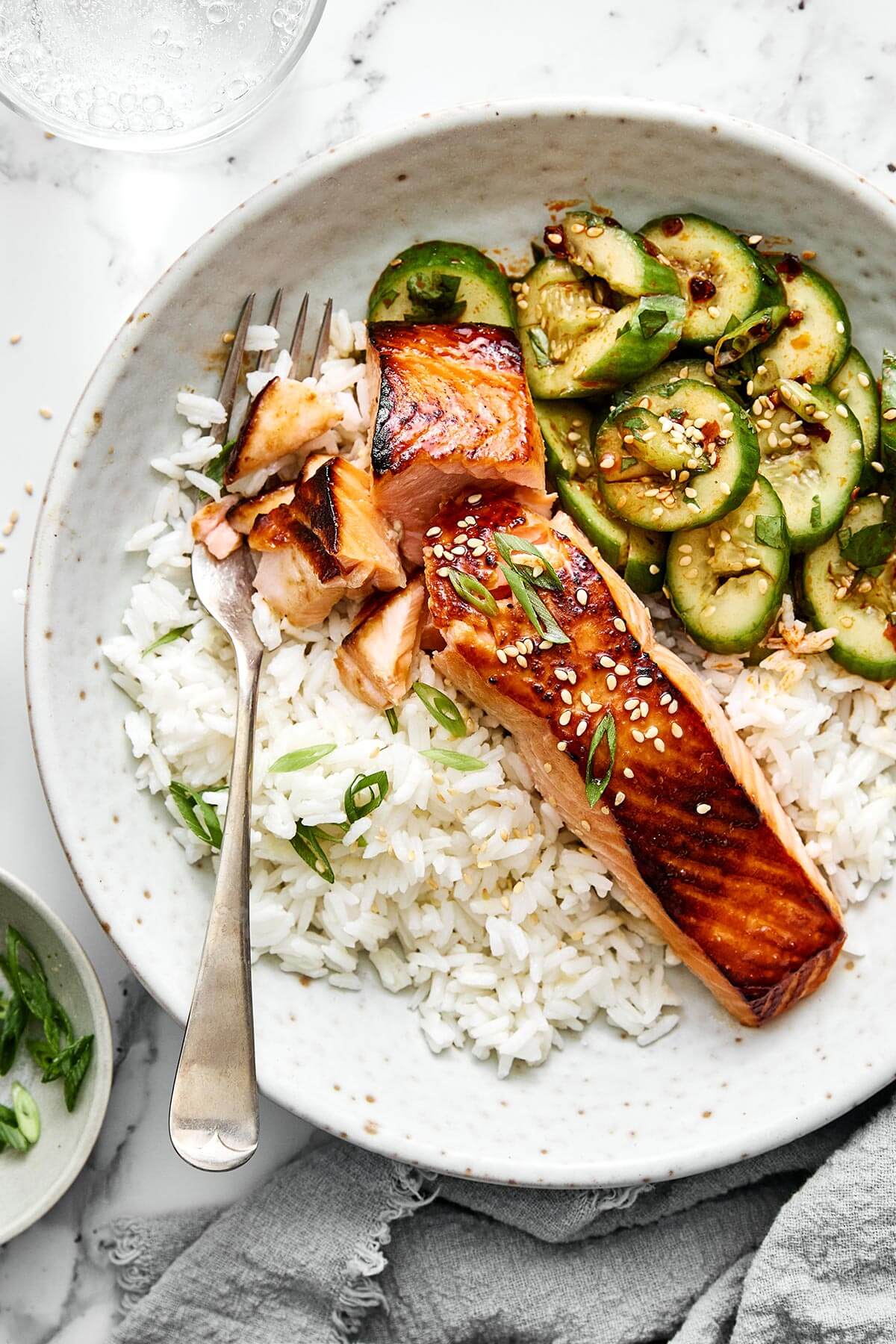 You'll crave this miso salmon time and again! It's incredibly simple, packed with umami flavor, and broiled to perfection in 7 minutes! A bowl of ginger rice, miso salmon, and cucumber salad.
