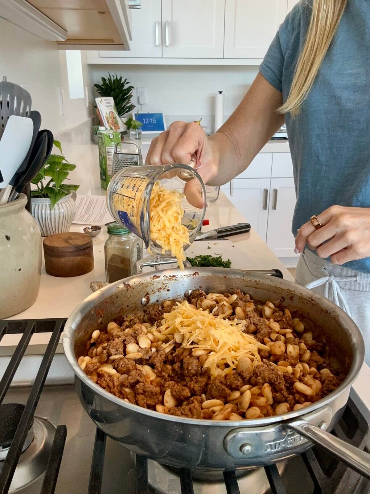 Lisa making healthy hamburger helper on the stovetop.