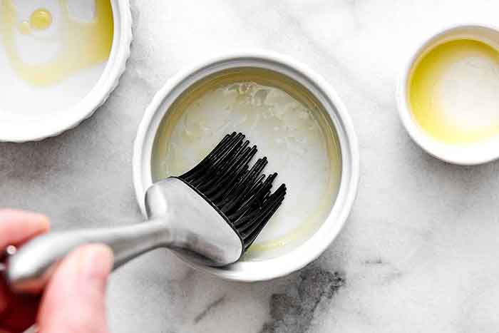 Oiling a ramekin.