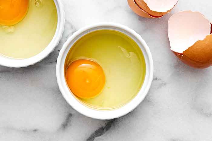 Cracked egg in ramekin.
