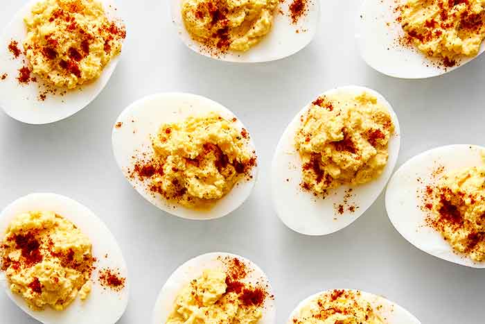 Deviled eggs on a white plate.