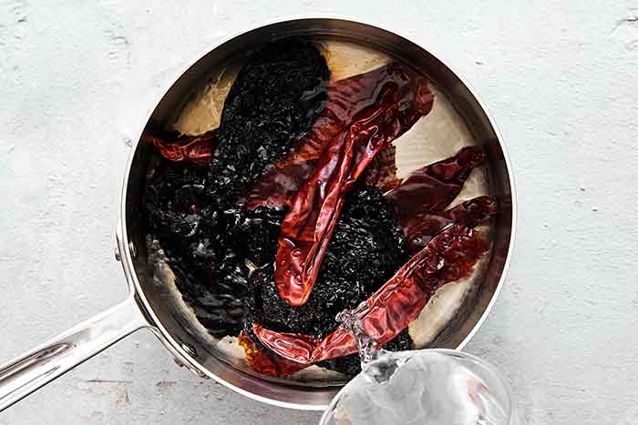 Chiles simmering in a pot.