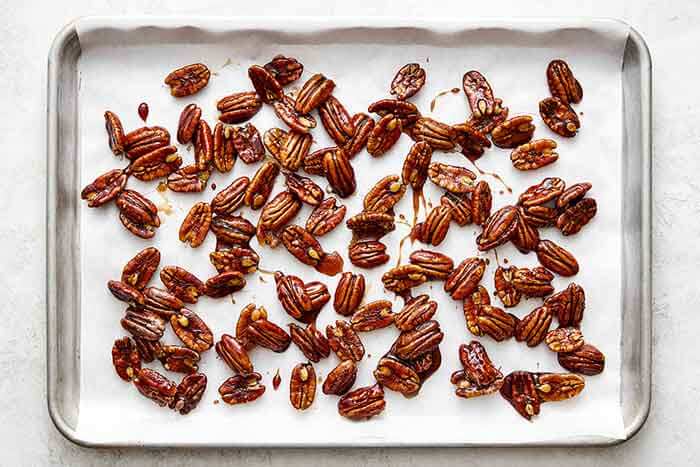 Letting candied pecans dry on a sheet pan.