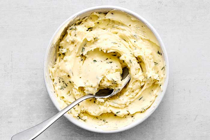 A bowl of herb butter mixture.
