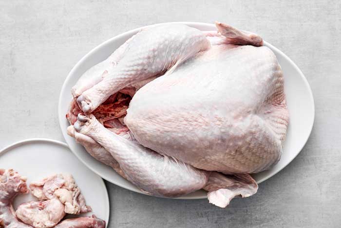 Turkey on a plate with giblets removed.