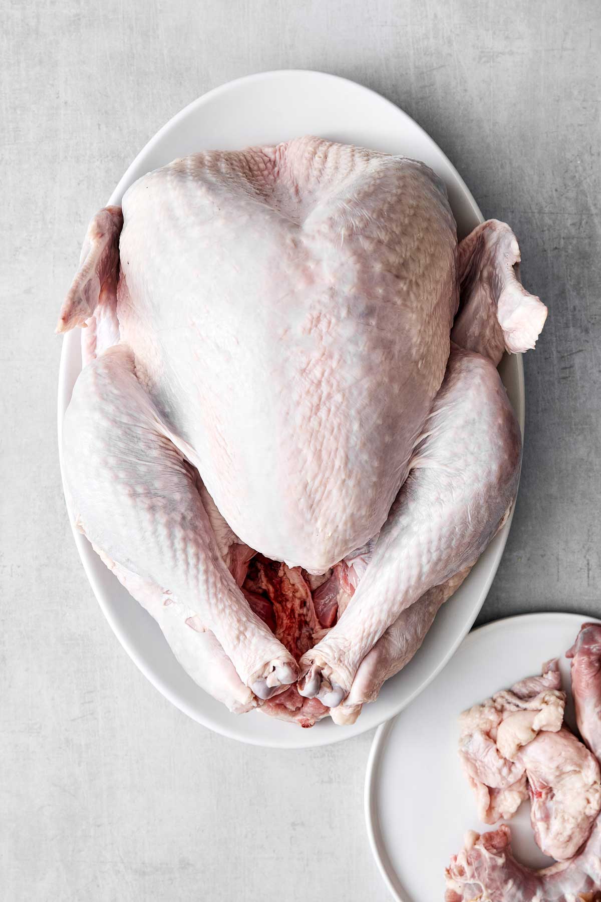 Turkey on a plate with the giblets removed.