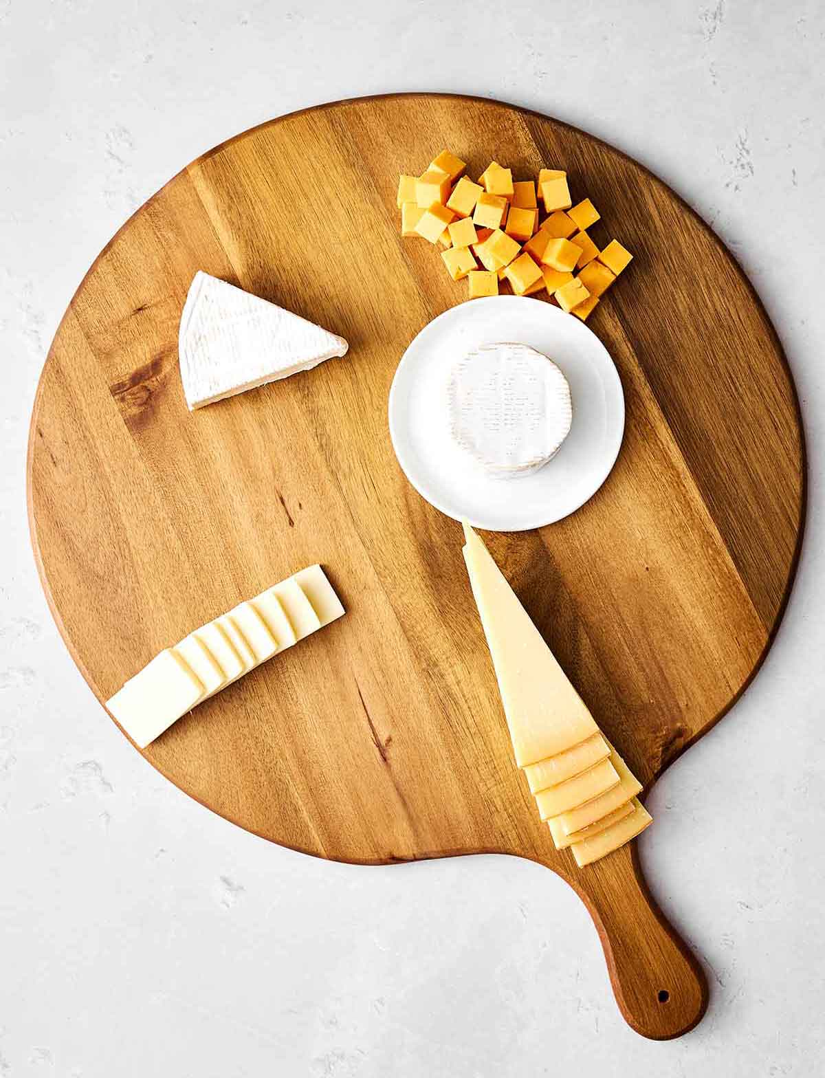 Step one of a charcuterie: Place the cheeses.