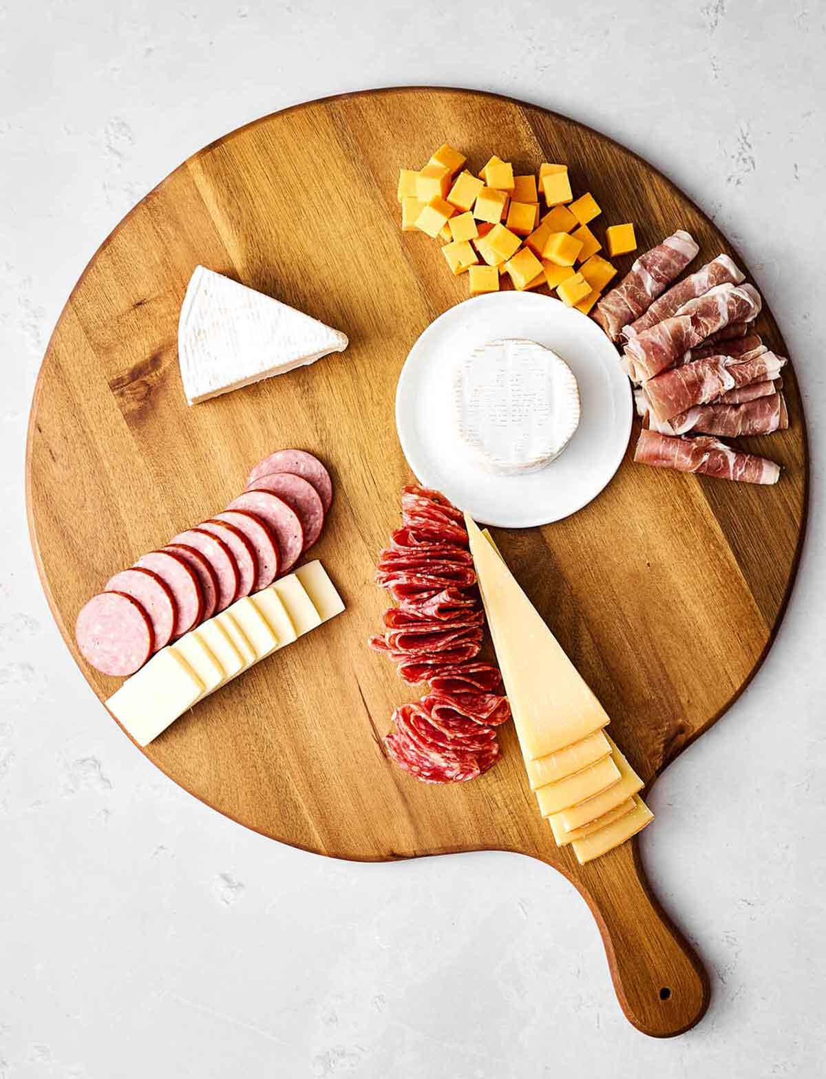 Step two of a charcuterie: Add the meats.