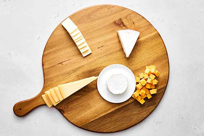 Step one of a charcuterie: Place the cheeses.