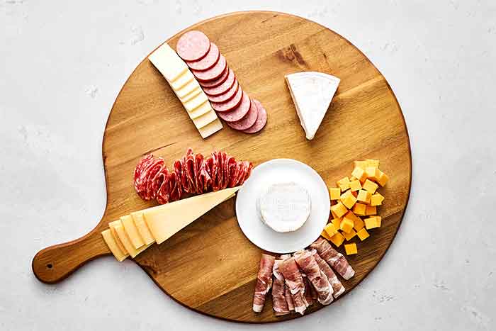 Step two of a charcuterie: Add the meats.