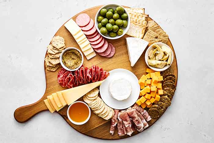 Step three of a charcuterie: Add crackers.