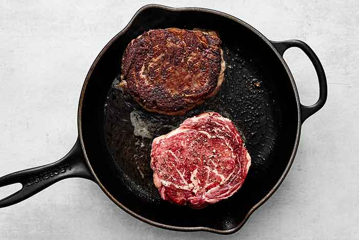 Step three: Searing ribeye steaks.