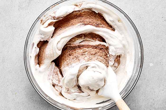 Step three: folding the cream into the chocolate for a chocolate mousse.