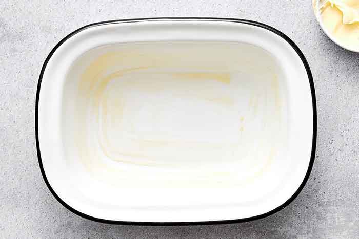 Step one of shirred eggs: Grease the ramekin.