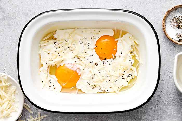 Step two of shirred eggs: Adding the cream and cheese.