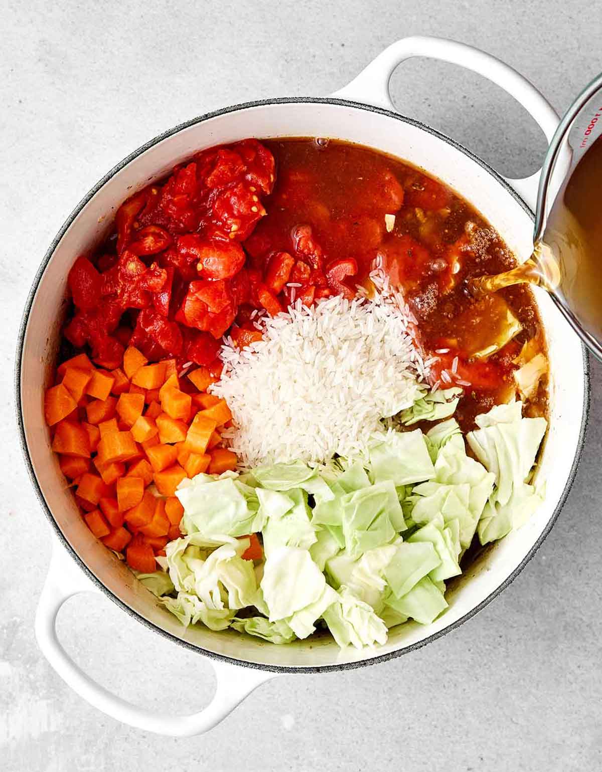 Step three of cabbage roll soup: add vegetables.