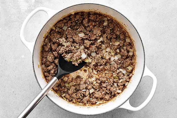Step one of cabbage roll soup: cook ground beef.