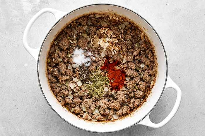 Step two of cabbage roll soup: add seasoning.