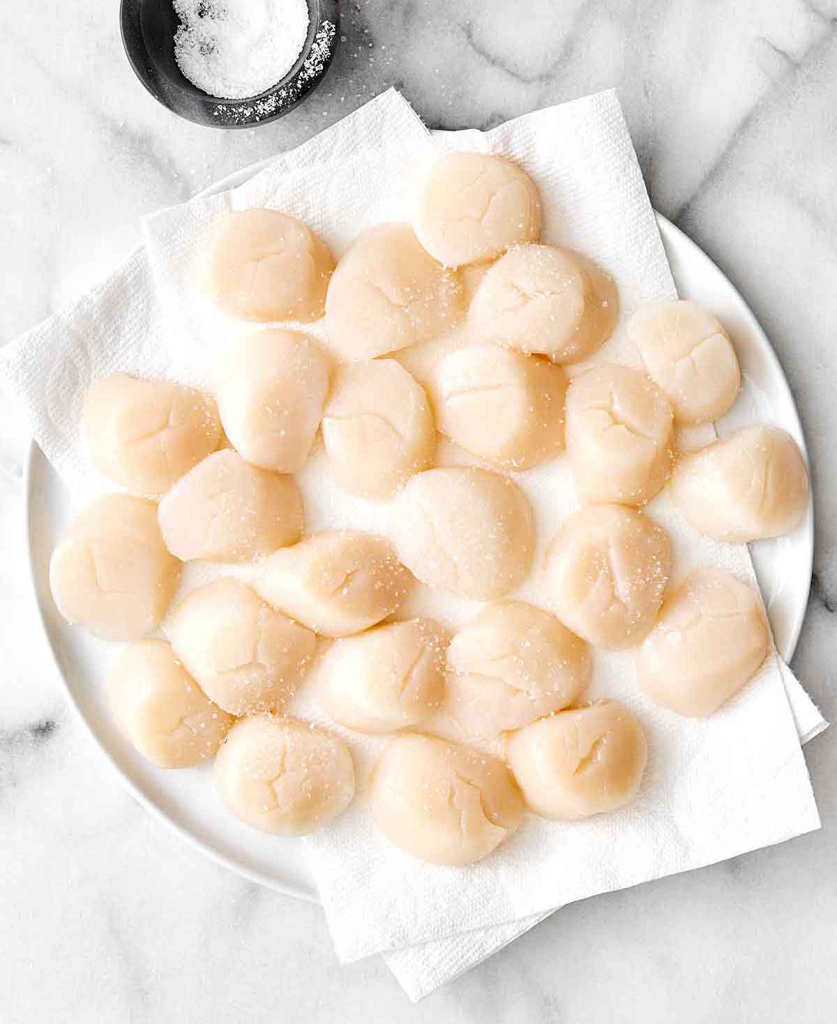 Step one of seared scallops: pat scallops dry.