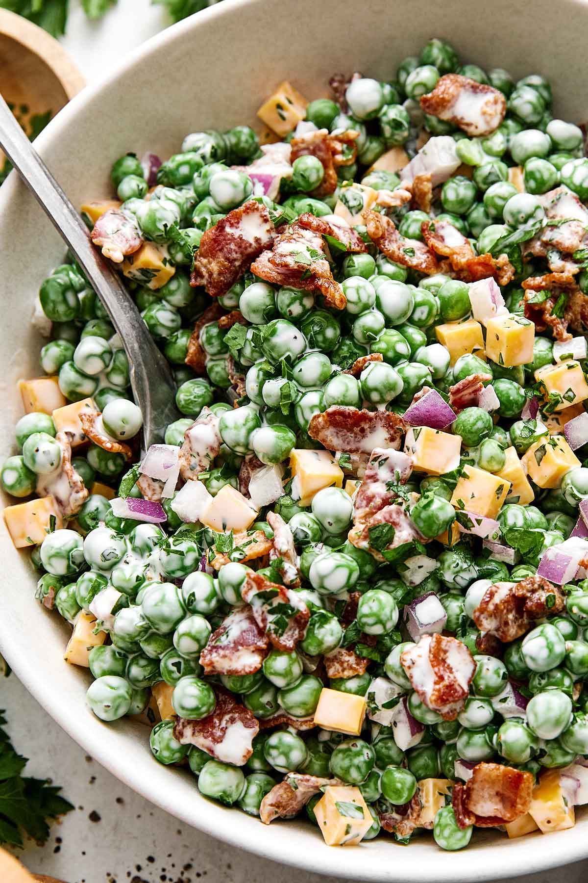 This creamy pea salad has become a spring and summer staple! It's simple, flavorful, and perfect for potlucks and group gatherings. Pea salad recipe.