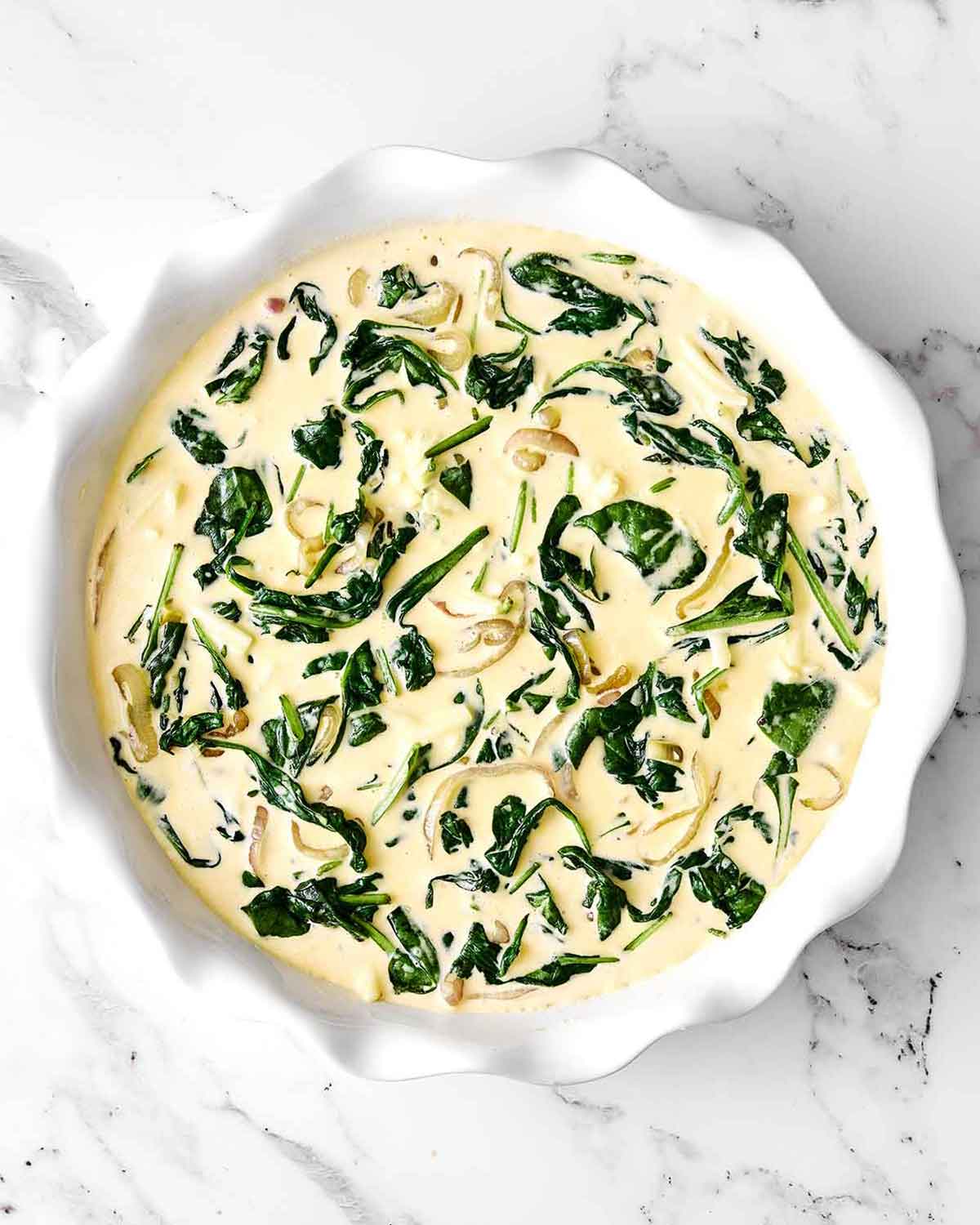 Step four of crustless quiche: add the veggies.