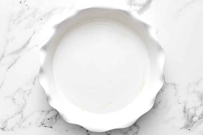 Step one of crustless quiche: oil the baking dish.