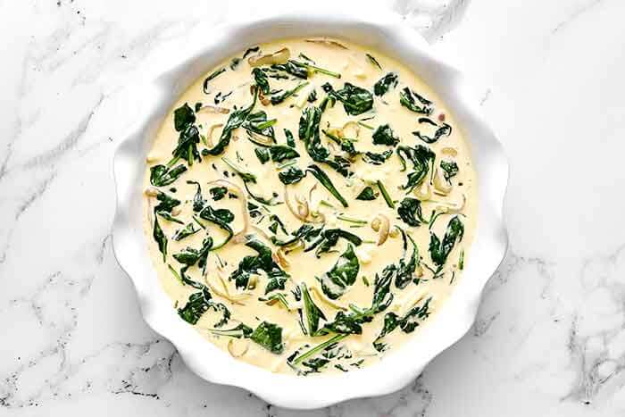 Step four of crustless quiche: add the veggies.