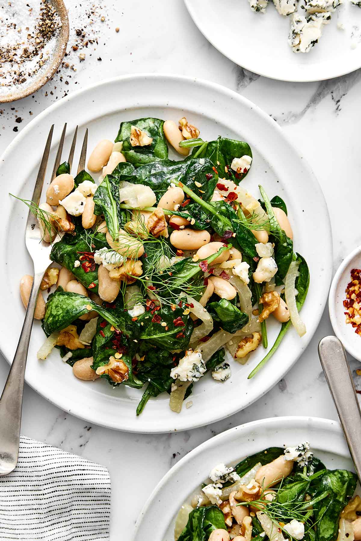 This warm spinach and white bean salad is my nudge to make more warm salads! It’s simple yet savory, healthy, and perfect for colder months. Warm spinach and white bean salad.