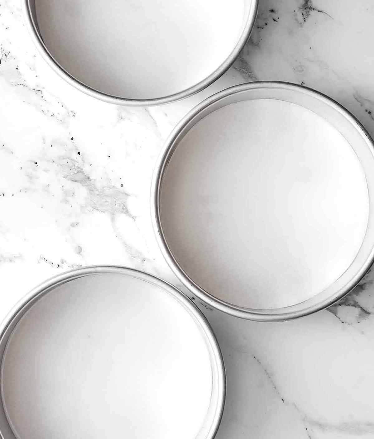 Step one of gluten-free carrot cake: line the pans.