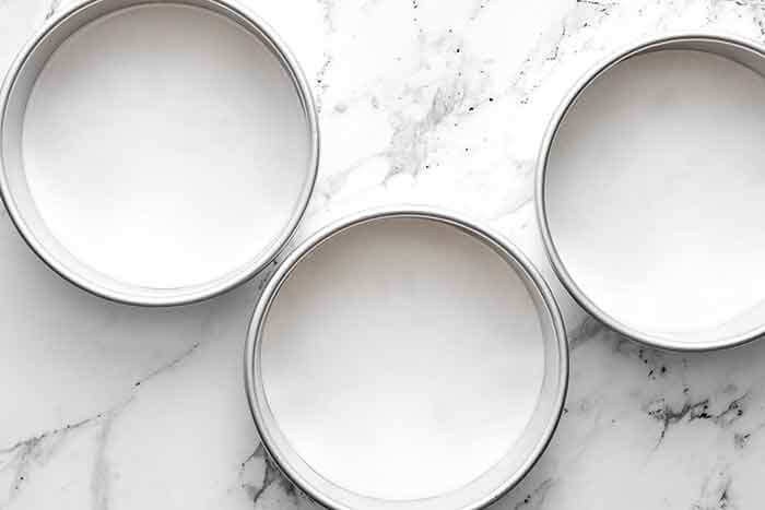 Step one of gluten-free carrot cake: line the pans.