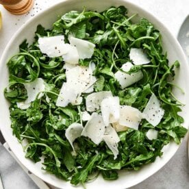 Simple arugula salad recipe in a bowl.