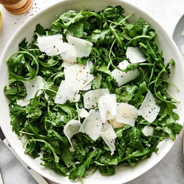 Simple arugula salad recipe in a bowl.