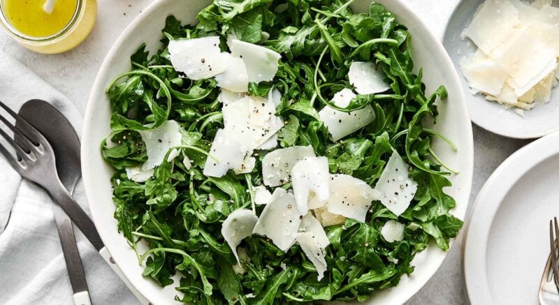 Simple arugula salad recipe in a bowl.