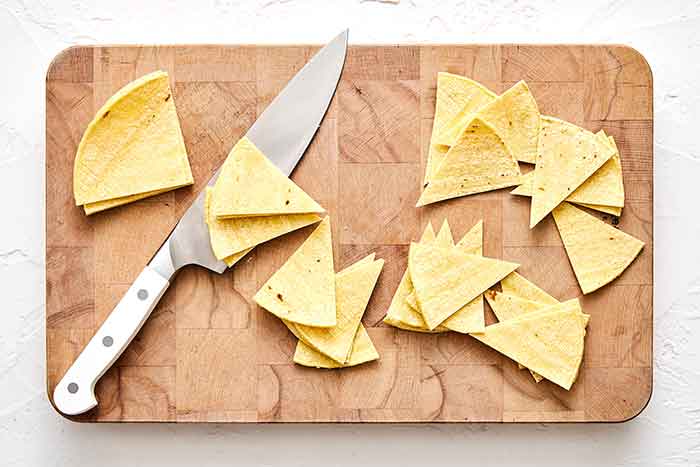 Step one chilaquiles: slice tortillas.