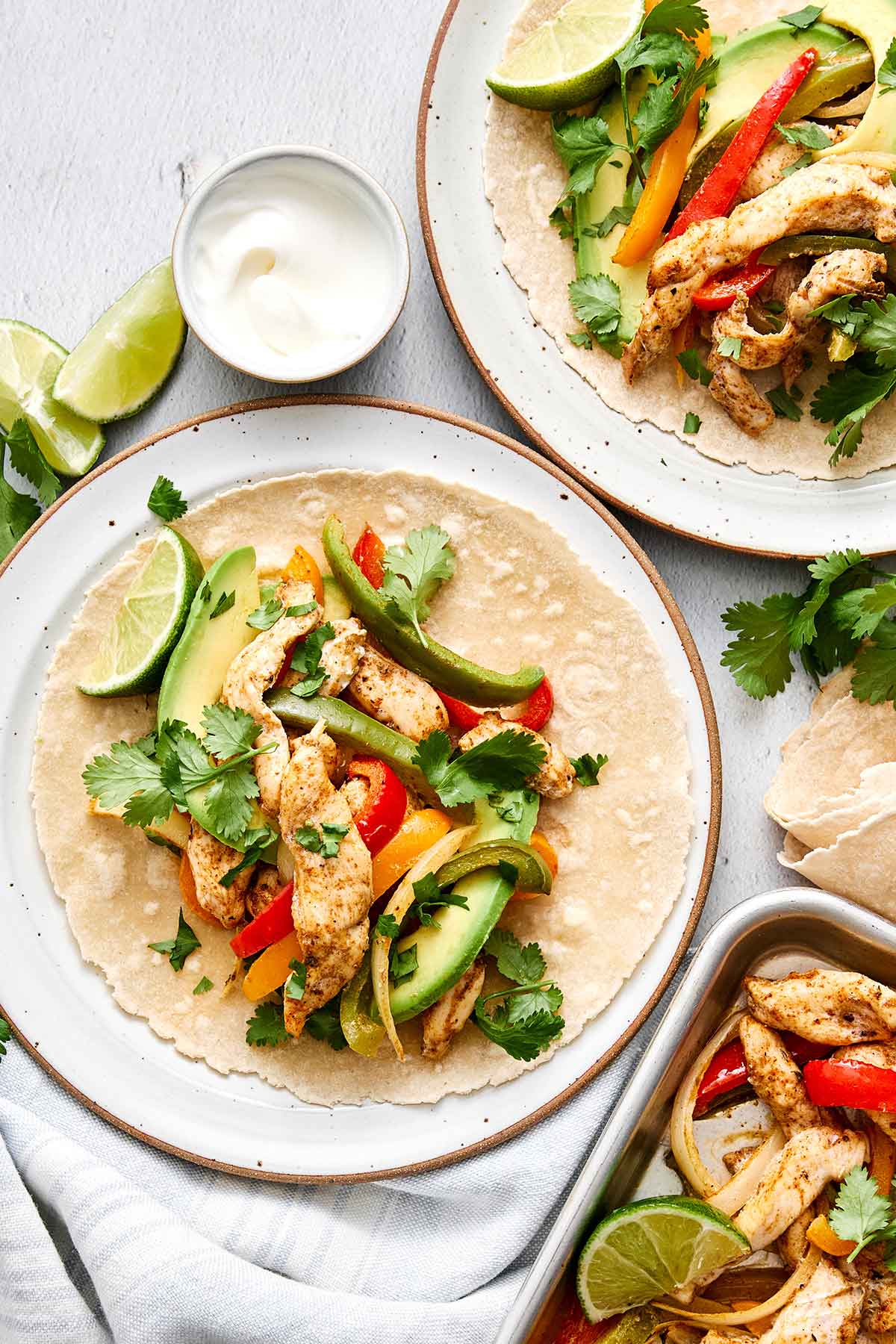 Sheet pan chicken fajitas with tortillas.