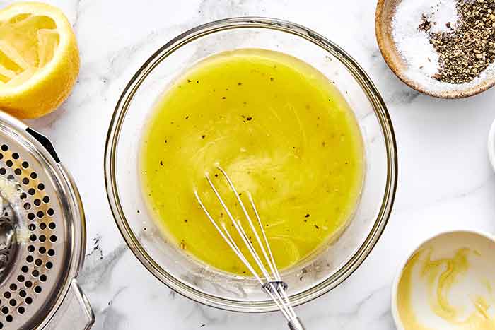Mixing lemon vinaigrette for quinoa salad.