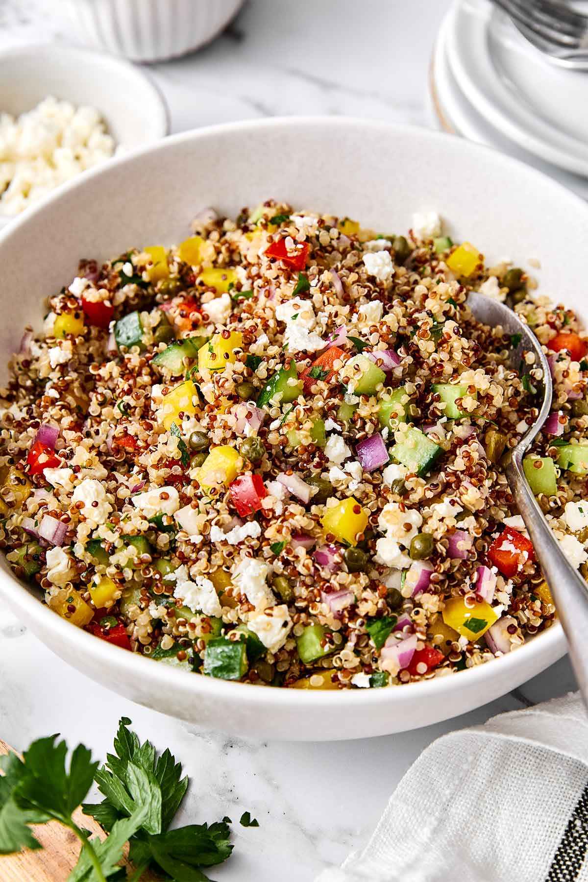 This is the Mediterranean quinoa salad I always make! It hits the perfect balance of fresh, briny, and satisfying...and it hold up well. A bowl of Mediterranean quinoa salad.