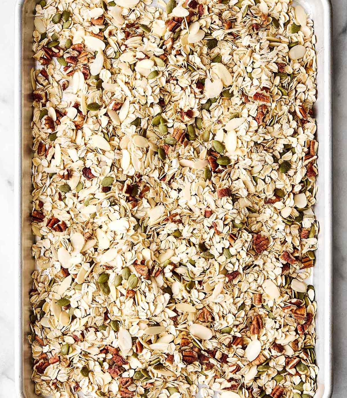 Toasting muesli ingredients on a sheet pan.