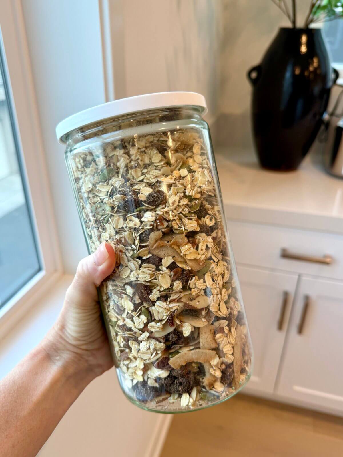 Lisa holding a glass jar of homemade muesli.