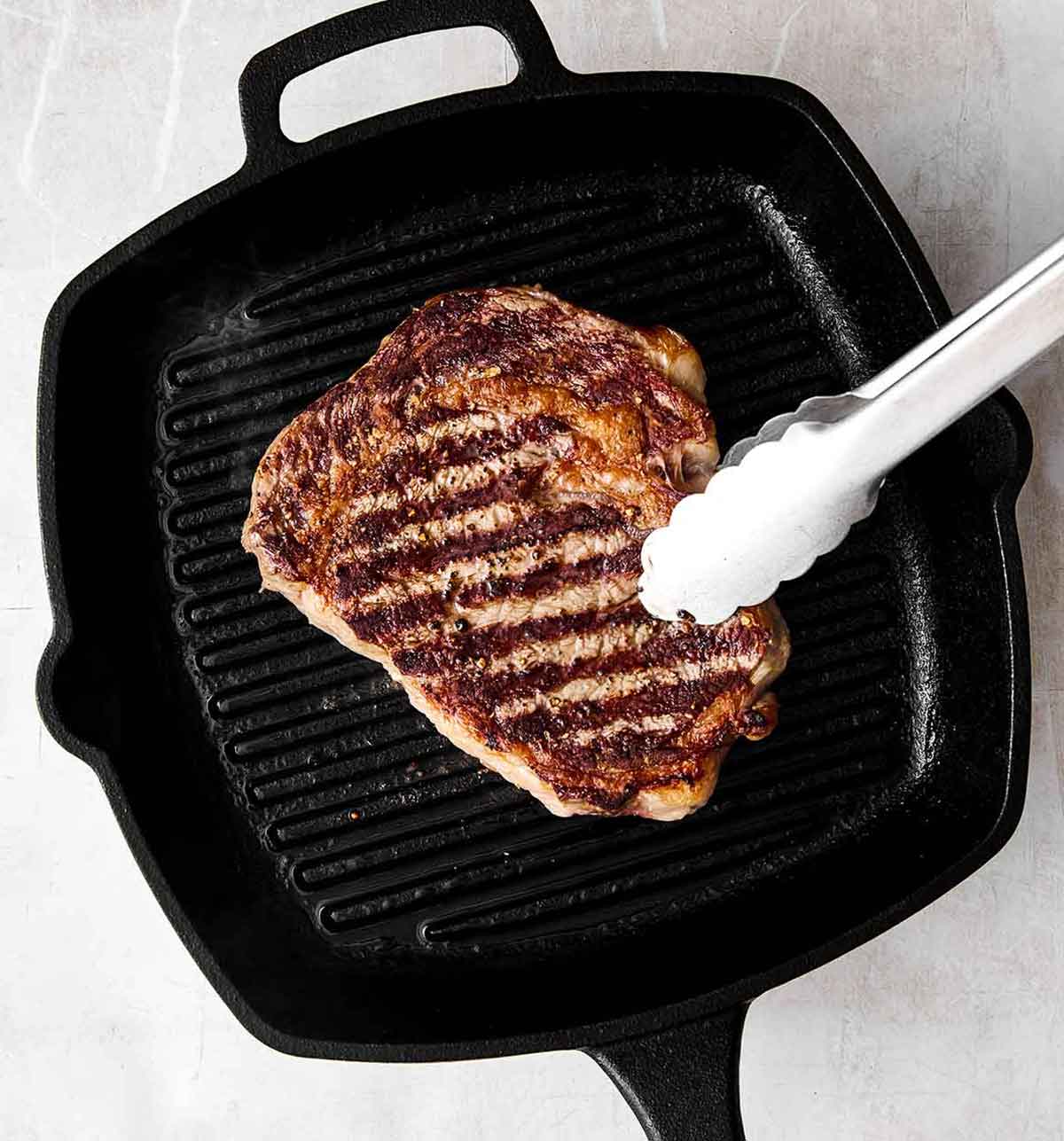 Grilling steak on a grill pan.