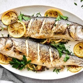 Whole roasted brazino recipe on a plate.