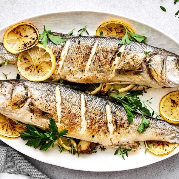 Whole roasted brazino recipe on a plate.