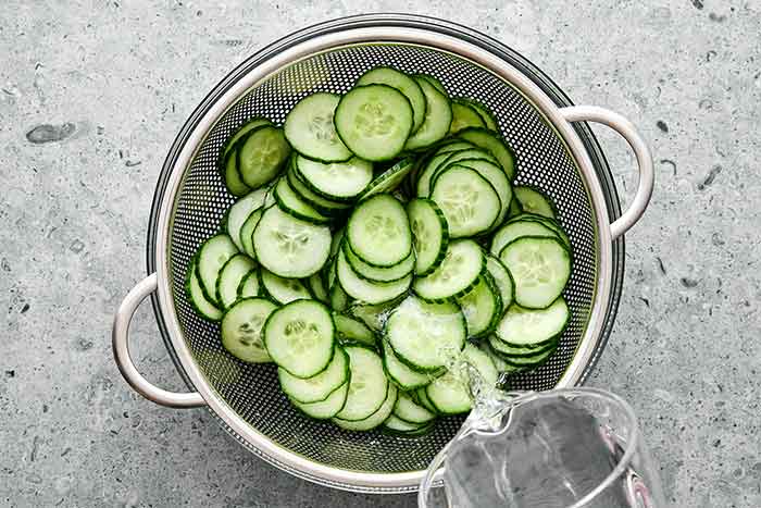 Rinsing salt from cucumbers.